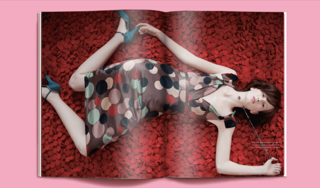 A woman laying on the ground in a dress.